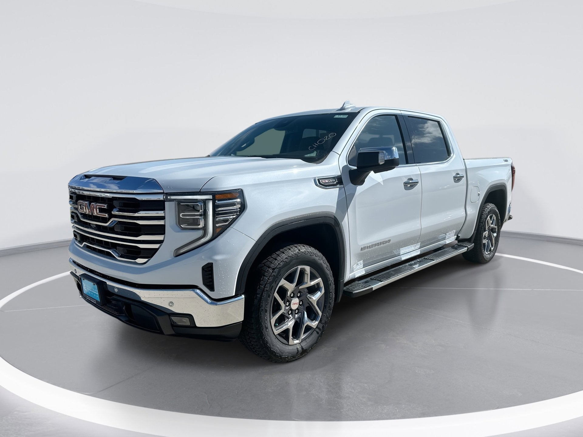 2026 GMC Sierra 1500 SLT in Glacier White Tricoat — front three-quarter view